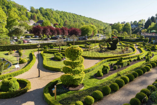 Beautiful green garden from top view. Abstract curves. Bright blue clear sky. Durbuy, Belgium - Starpik