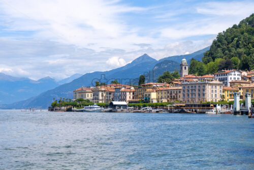 Bellagio city from side view. Mountains and cloudy sky on background. Lake Como, Italy - Starpik