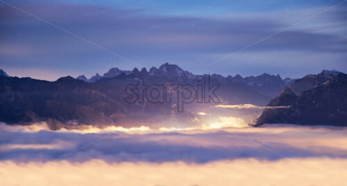 Belluno mountains above clouds at sunset. Italy beauties - Starpik