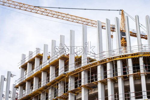 Building in construction with a huge crane in the background, Brussels, Belgium - Starpik