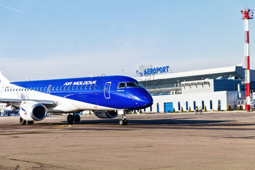 CHISINAU, MOLDOVA – DECEMBER 15, 2017: Air Moldova embraer aircraft on international airport of the country, arriving terminal - Starpik