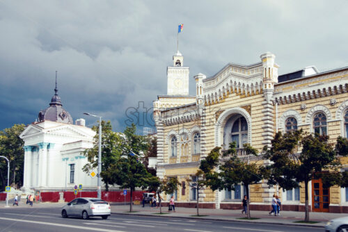 CHISINAU, MOLDOVA – JULY 24, 2018: architecture of the town hall and city municipality building before rain with dark sky - Starpik