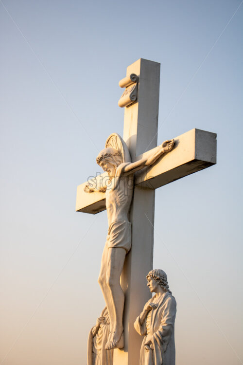 CRIULENI, MOLDOVA – AUGUST 21, 2018: Dramatic view to Statue of Jesus Christ. Sunset with no clouds - Starpik