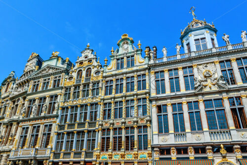 City buildings facade at Grand Place in a sunny day. Bright clear sky on background. Negative copy space, place for text. Brussels, Belgium - Starpik