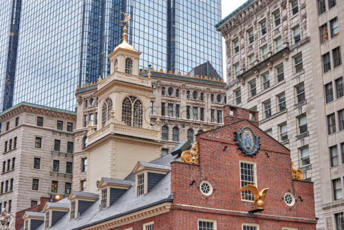 Close-up shot of Old State House in Boston with multiple gorgeous aged and modern buildings in the background - Starpik