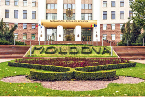 Close-up shot of the country parliament. Flowers in little garden in front. Chisinau, Moldova - Starpik