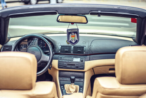 Close-up view to a car with Moldova sign hanging. Car travel idea. Chisinau city - Starpik