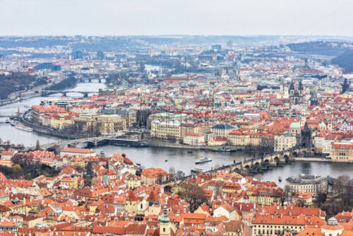 Cloudy and foggy day aerial view to clay pot roofs, parks, roads and Vltava river with bridges. Ships cruising on water. Negative copy space, place for text. Old town, Prague, Czech Republic - Starpik