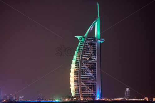 DUBAI, UNITED ARAB EMIRATES – FEBRUARY 23, 2019: Burj Al Arab with colorful lights at night - Starpik