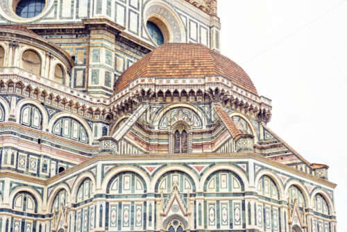 Daylight cloudy day view from bottom to ornamented facade of Cathedral Saint Mary of the Flower. Florence, Italy - Starpik