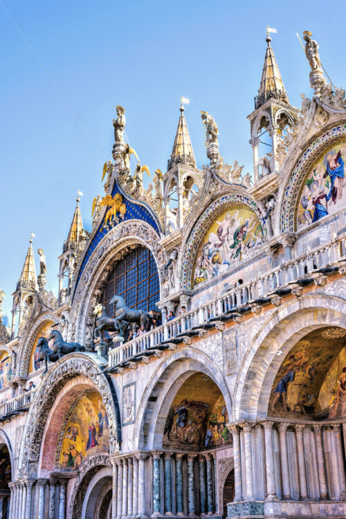 Daylight view from square to Saint Mark’s Basilica cathedral church with famous drawings. Bright blue clear sky. Negative copy space, place for text. Venice, Italy - Starpik