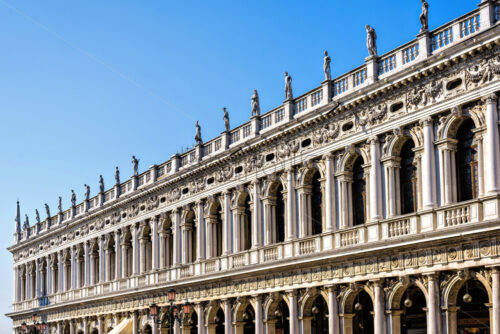 Daylight view to Marciana Library renaissance style facade from Saint Mark’s square. Bright blue clear sky. Negative copy space, place for text. Venice, Italy - Starpik