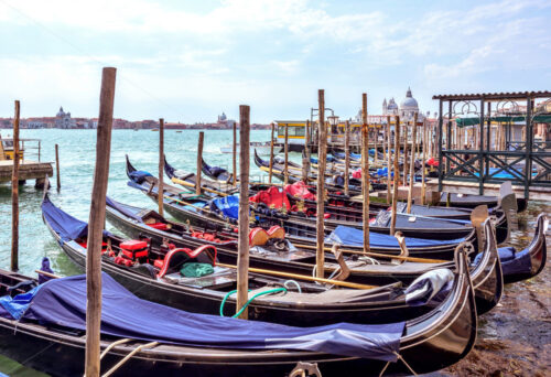 Daylight view to parked boats, historic architecture buildings and people walking on pier. Bright blue sky with clouds. Place for text. Energetic mood - Starpik