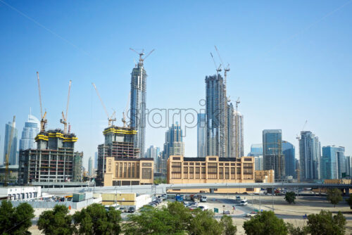 Dubai City with construction cranes working at daylight. United Arab Emirates - Starpik