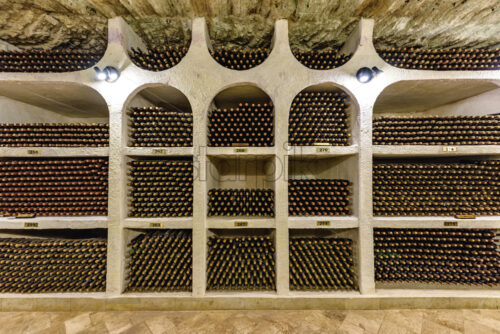 Famous wine cellars racks in wide perspective. Bright lights illuminating interior. Old stone ceiling, cricova, moldova - Starpik