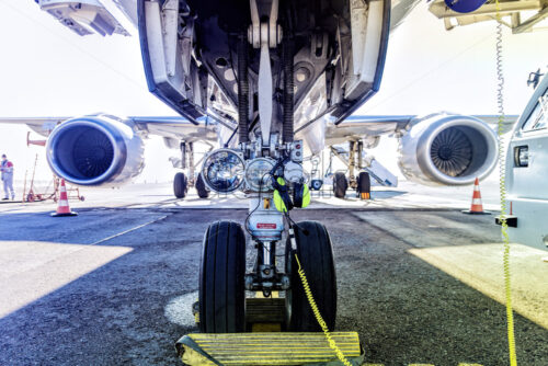 Fueling and final checking aircraft before taking off, view of the wing hose engine at airport service, plane landing gear - Starpik