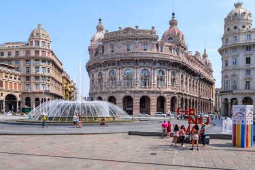 GENOA, ITALY – AUGUST 05, 2018: Piazza De Ferrari with buildings and people on promenade. Genova red sign - Starpik