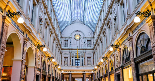 Galeries Royales Saint-Hubert at sunset with warm lights glowing. Brussels, Belgium - Starpik