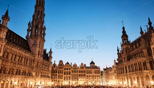 Grand Place with people at evening. Blue Hour in Brussels, Belgium - Starpik