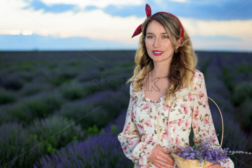 Happy blonde woman in lavender field at sunset in Moldova, summer flowers dress - Starpik