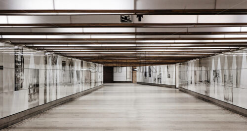 Illuminated underpass with art on walls and no people. Brussels, Belgium - Starpik