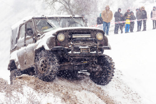 Jeeps compeating in winter rally competition with mud and snow. Magdacesti, Moldova - Starpik