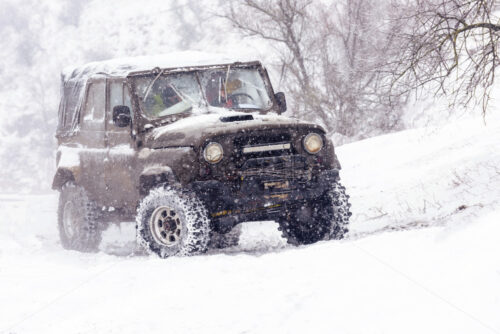 Jeeps compeating in winter rally competition with mud and snow. Magdacesti, Moldova - Starpik