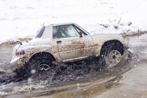 Jeeps compeating in winter rally competition with mud and snow. Magdacesti, Moldova - Starpik