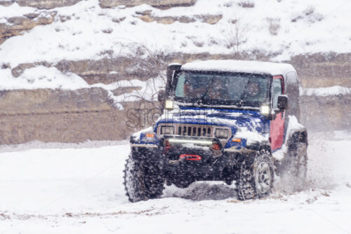 Jeeps compeating in winter rally competition with mud and snow. Magdacesti, Moldova - Starpik