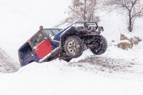 Jeeps compeating in winter rally competition with mud and snow. Magdacesti, Moldova - Starpik