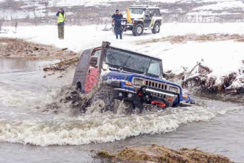 Jeeps compeating in winter rally competition with mud and snow. Magdacesti, Moldova - Starpik