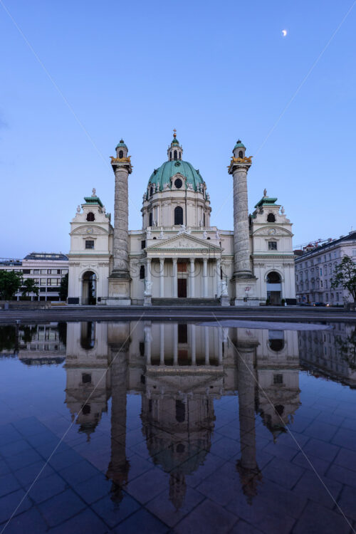 Karlskirche in Vienna Austria at sunset with reflection and shining moon in the purple sky, St Charles’s church - Starpik