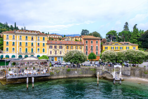 LOMBARDY, ITALY – AUGUST 03, 2018: Bellagio city shore with people and parked cars. View from Lake Como - Starpik