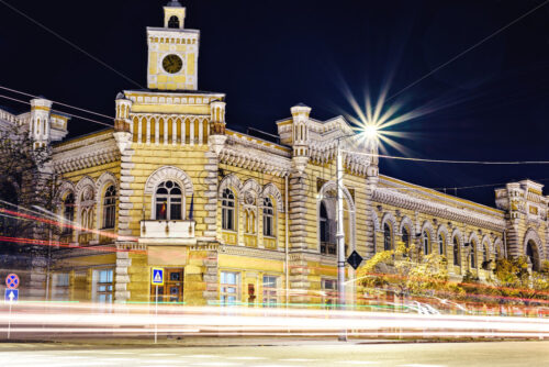 Long exposure shot of Town Hall at night. Colorful bright light trails from cars. Negative copy space, place for text - Starpik