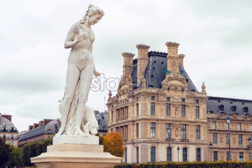 Marble lady statue that is looking to Louvre museum. Cloudy day with a chance of raining. Sad wheather in Paris, France - Starpik