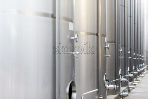 Metallic wine barrels at a winery, perspective view - Starpik