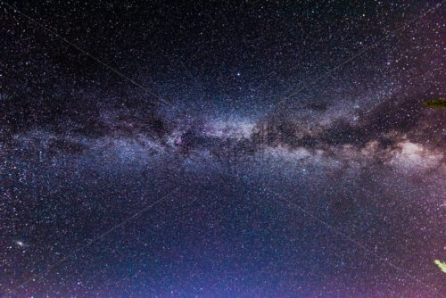 Milky way stars at night over dark black purple sky - Starpik