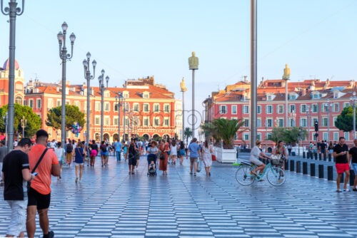 NICE, FRANCE – AUGUST 07, 2018: Promenade du Paillon at sunset. People walking on street. - Starpik