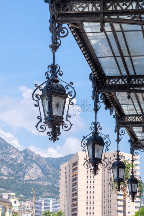 Old hanging lamps in Monte Carlo. City on background. Monaco beauties - Starpik