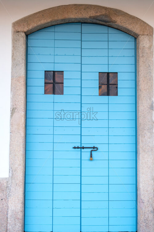 Old warehouse blue door in Porto Antico. Genoa, Italy - Starpik