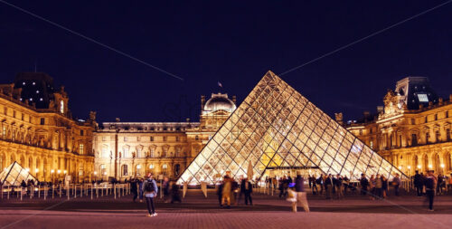 PARIS, FRANCE – 3 OCTOBER 2018: Louvre Museum at night with lights and people - Starpik