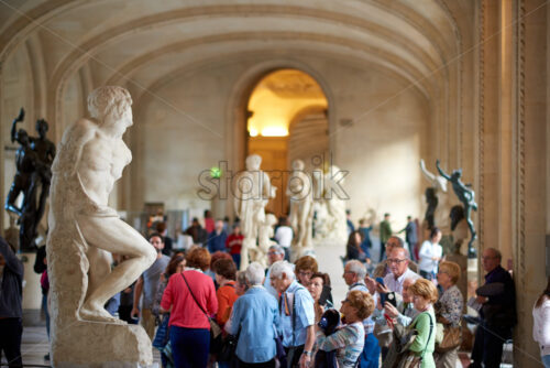 PARIS, FRANCE – OCTOBER 03, 2018: People taking photos of sculptures in Louvre Museum - Starpik