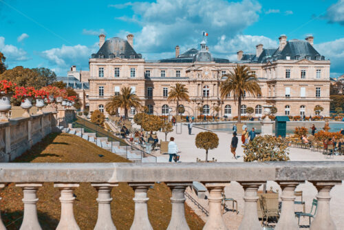 PARIS, FRANCE – SEPTEMBER 09, 2018: The Luxembourg Gardens at daylight. People walking in front. Orange and teal colors - Starpik