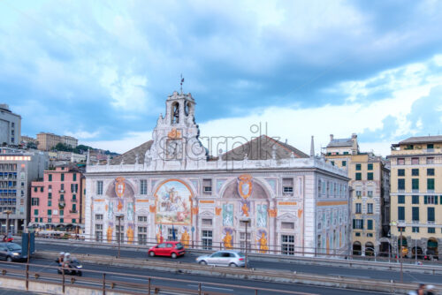 Palace of St. George at sunset. Cars riding on highway. Cloudy sky on background. Genoa, Italy - Starpik