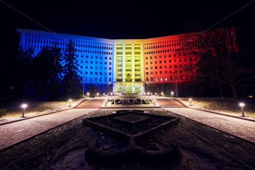 Parliament of Moldova at night with Romanian Flag colors reflecting on building. Chisinau beauties - Starpik