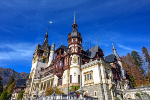 Peles Castle at daylight in autumn colors. Clouds on background. Close-up shot. Sinaia, Romania - Starpik