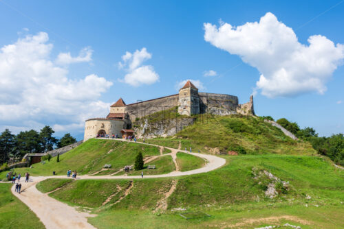 RASNOV, ROMANIA – AUGUST 18, 2019: People walking near Rasnov Citadel in sunlight. Distance shot. Top view - Starpik