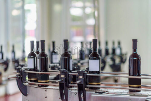 Red wine bottling and sealing conveyor line at winery factory - Starpik