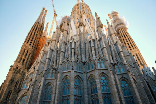 Sagrada Familia church from bottom view. Clear sunset sky, Barcelona, Spain - Starpik