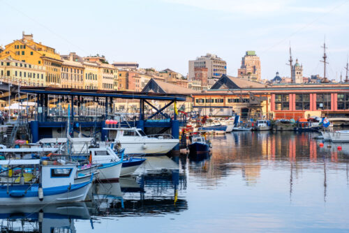 Ships parked in Porto Antico at sunset. Genoa, Italy - Starpik